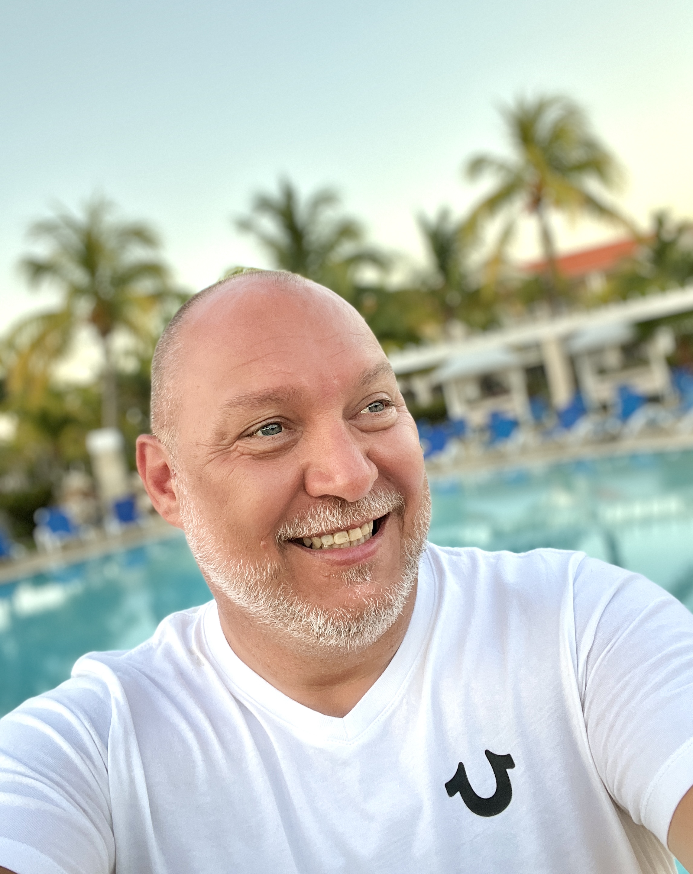 Roland Bast smiling at a swimming pool, original photograph supplied by Roland